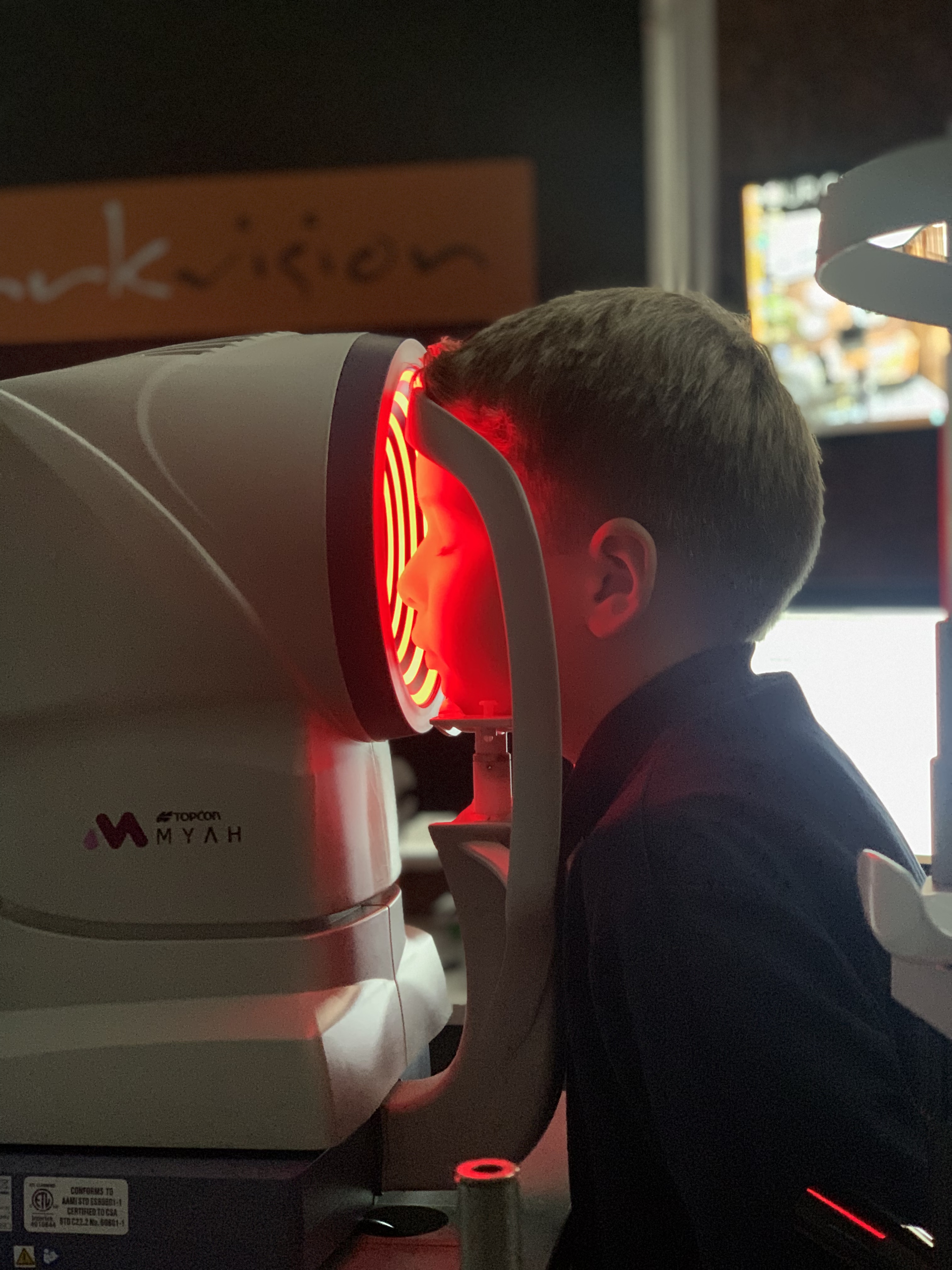 Young boy receiving a myopic eye scan