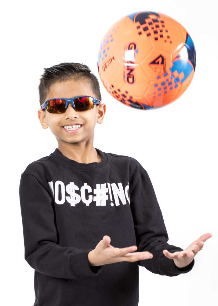 Young boy wearing stylish sports sunglasses