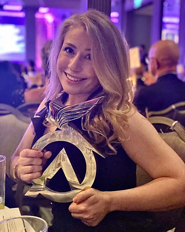 Camilla holding the Optician Awards trophy