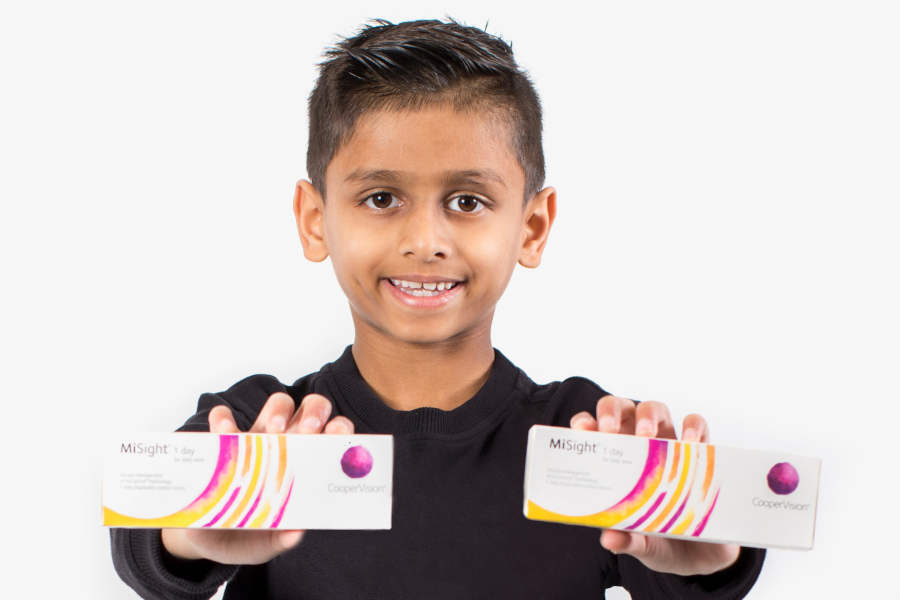 Young boy holding the MiSight contact lens boxes