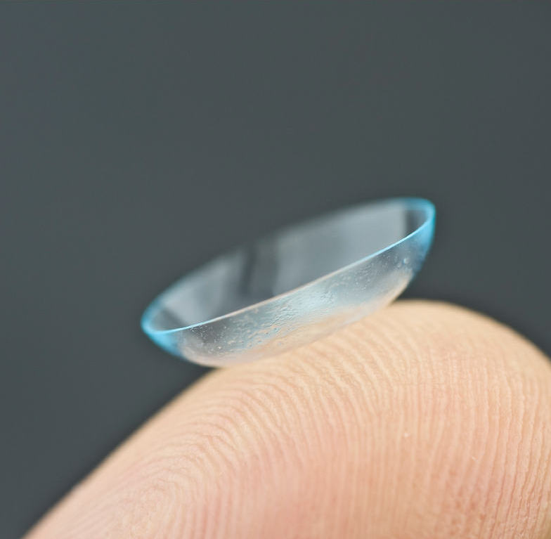 Contact lens on fingertip