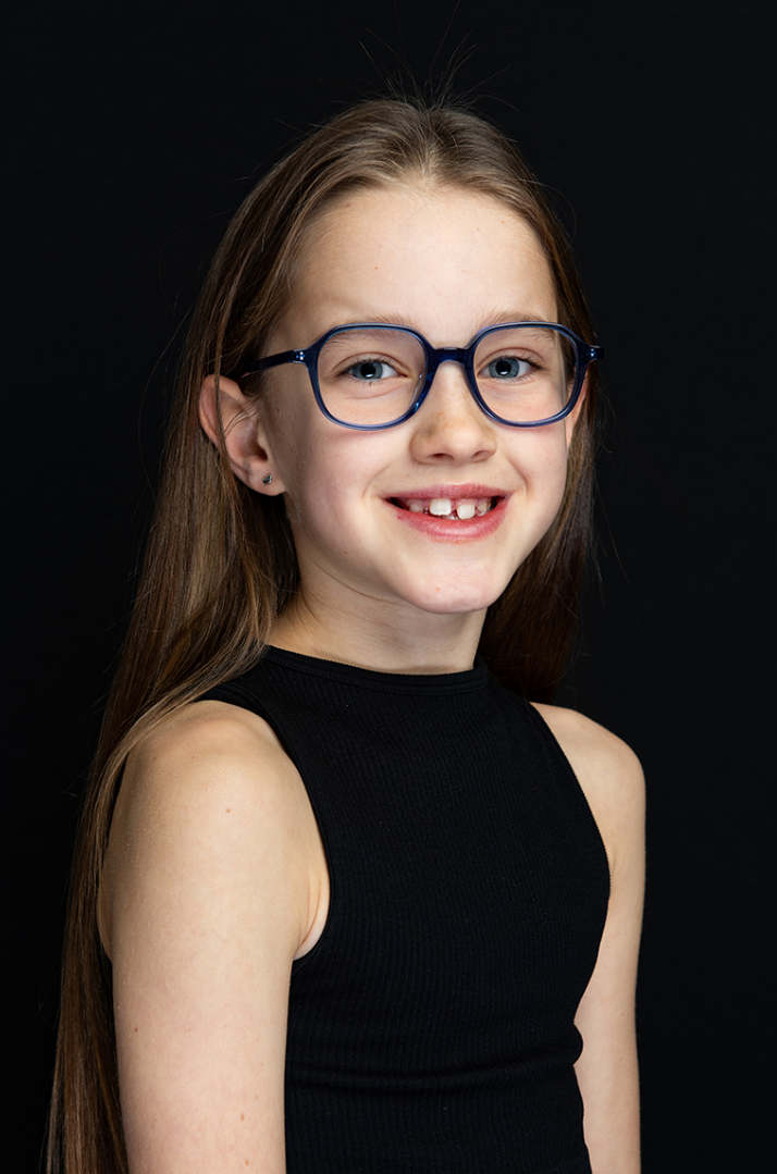 Girl wearing Miyosmart spectacle lenses for childhood Myopia management